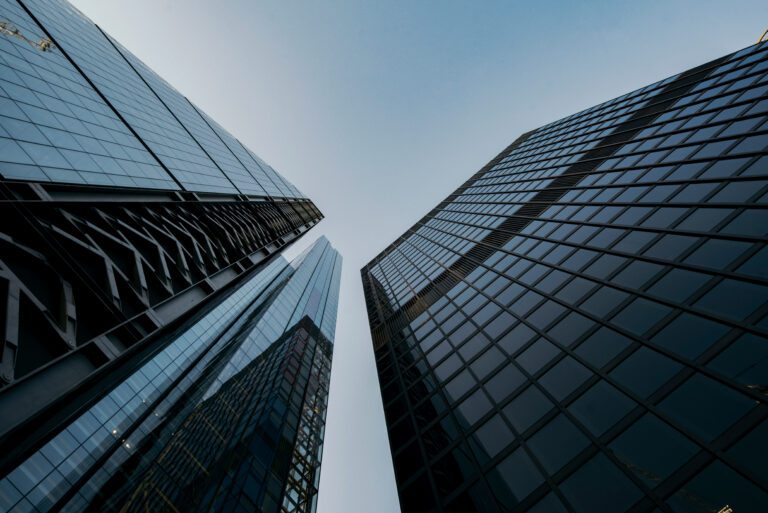 Business building with sky and clouds reflection