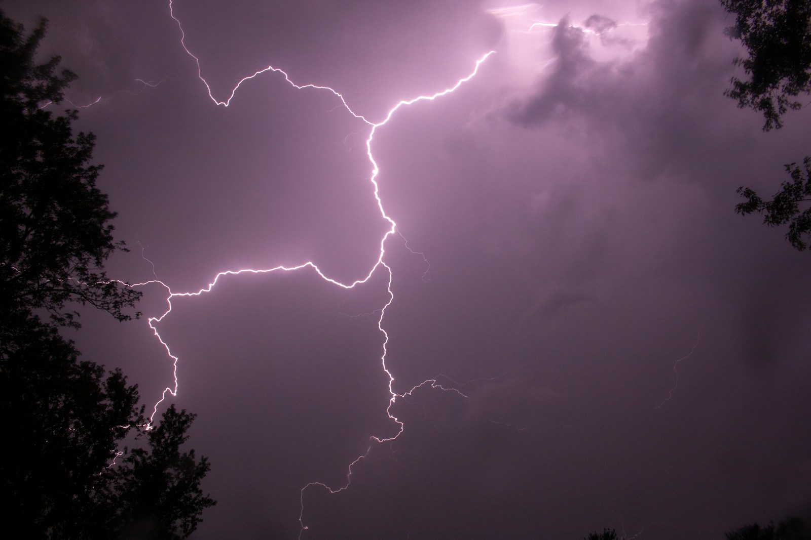 a lightning bolt hitting through a cloudy sky
