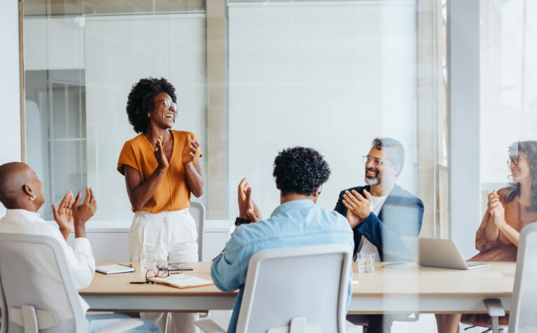 Successful business meeting with a creative team applauding their colleagues' project