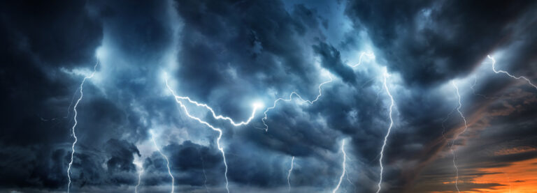 Lightning thunderstorm flash over the night sky